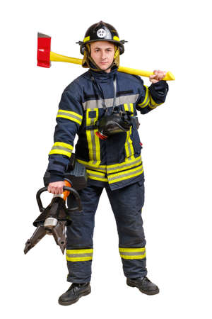 Full body young brave man in uniform of firefighter holds cordless combined tool for spreading, cutting, squeezing and axe on shoulders looking at camera isolated on whiteの写真素材