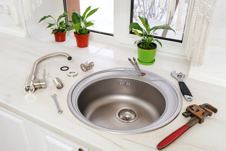 New faucet and tools for installing into the kitchen sink, plumbing work or renovation concept.の写真素材