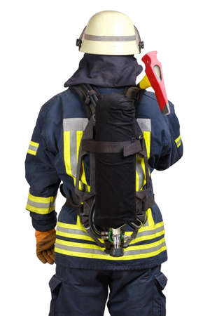 Close up rear view of fireman in fire-proof uniform and hardhat with air tank on his back and axe on shoulders over white background isolated.の写真素材