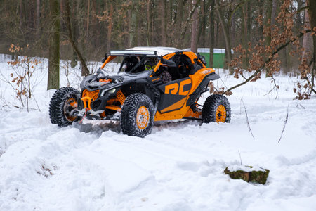 KYIV, UKRAINE - FEBRUARY 21: A man rides a buggy in a snowy winter park. Seasonal leisure concept