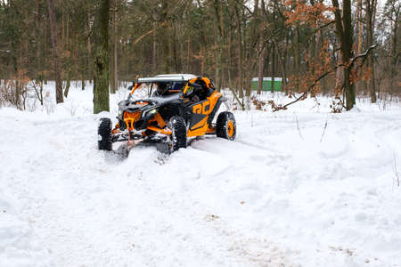 KYIV, UKRAINE - FEBRUARY 21, 2021: A man rides a buggy in a snowy winter park. Seasonal leisure conceptのeditorial素材