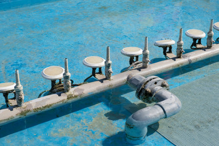 Fountain spray nozzles installed in the empty pool and led lights closeup. High quality photo