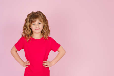Surprised cute little girl in Easter bunny ears headband against pink background, copy spaceの写真素材