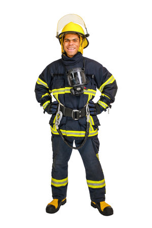 Full body young smiling African-American fireman in a fireproof uniform stands and looks at the camera. Isolated on white, vertical orientationの写真素材
