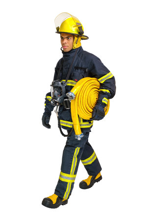 Full body young African American fireman in a fireproof uniform goes away in profile with fire hose in his hand. Isolated on white, vertical orientationの写真素材