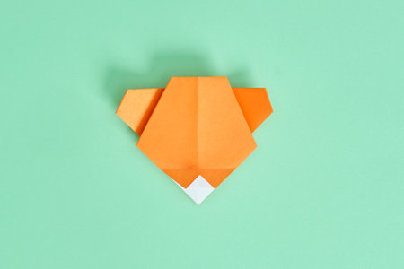 Origami Bear. Step-by-step photo instruction on a green background. DIY concept. Step10.の写真素材