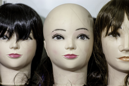 Dolls with unquieting coloured wigsの写真素材