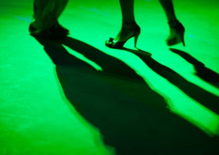 Detail of shoes with shadows in milonga ballroom.の写真素材