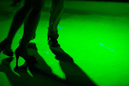 Detail of shoes with shadows in milonga ballroom.の写真素材