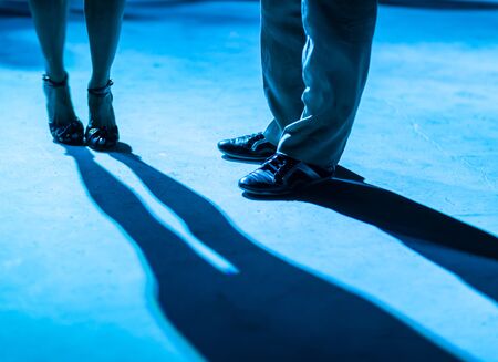 Detail of shoes with shadows in milonga ballroom.の写真素材