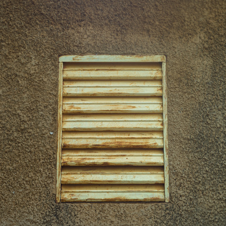 A shutter in mud house of village in Burkina Fasoの写真素材