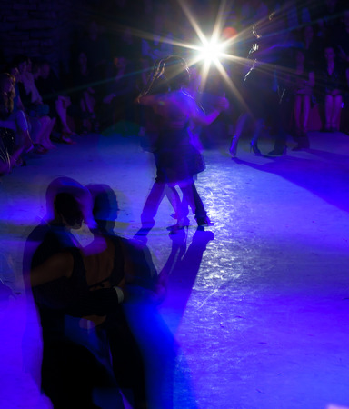 Silhouettes of tango dancers in milonga ballroomの写真素材