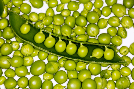 Fresh green peas close up on a white backroundの写真素材
