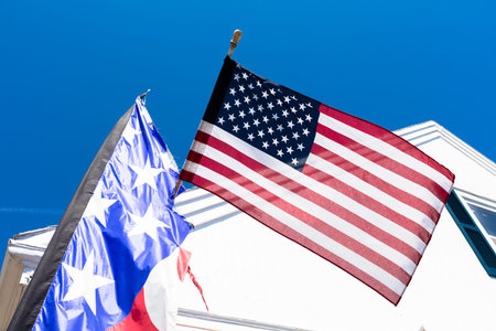 American flags with backround of typical house, New England