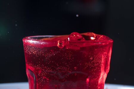drops of red liquid in glass beakerの写真素材