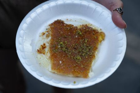 Arabic dessert Kunafa made with cheese and honey and pistacheの写真素材