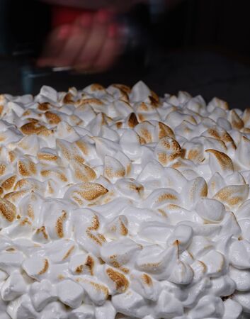 cake with caramelized meringue on a dark backgroundの写真素材