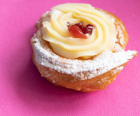 Zeppole of Saint Joseph, Italian pastry with flour, sugar, eggs, oil, decorated with a sour cherry. Father's Day cake.の写真素材