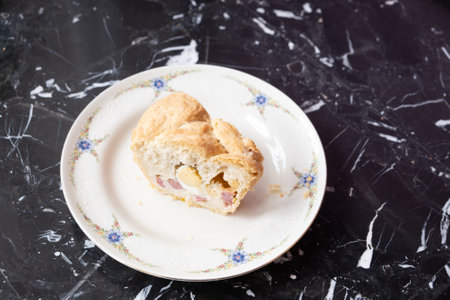 The tortano is a rustic Neapolitan salty donut, prepared for Easter, filled with cured meats, cheeses and cracklingsの写真素材