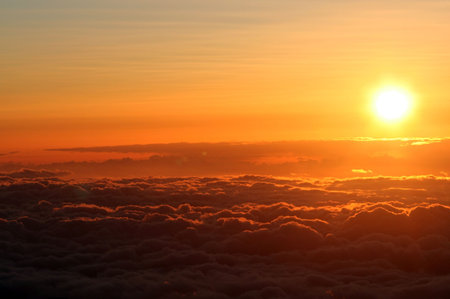 Sun setting above the clouds at 14,000 feet on Mauna Kea, Hawaiiの写真素材