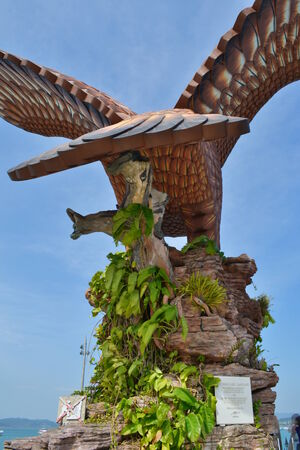 A statue of an eagle which is the iconic symbol for the Langkawian people at the Dataran Lang from the back point of view showing itの写真素材