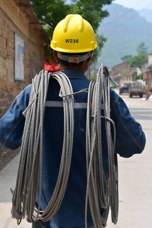 The backs of electric workersのeditorial素材