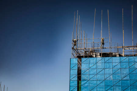 Construction site with scaffolding and blue sky background. High quality photoの写真素材