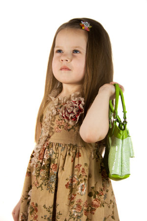 Little girl with green bag in a  shopping dayの写真素材