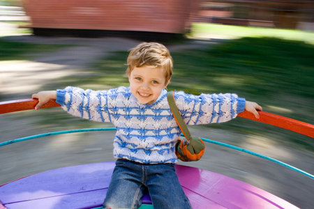 The happy little girl is turned on a roundaboutの写真素材