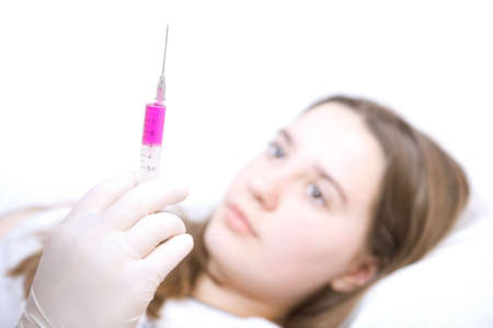 Doctor taking syringe and vaccination young patientの写真素材