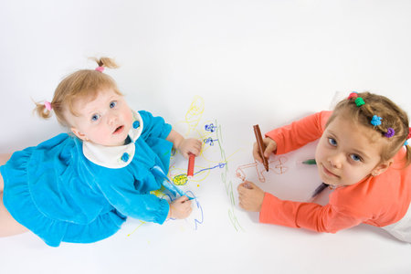 Two little caucasian girl painting