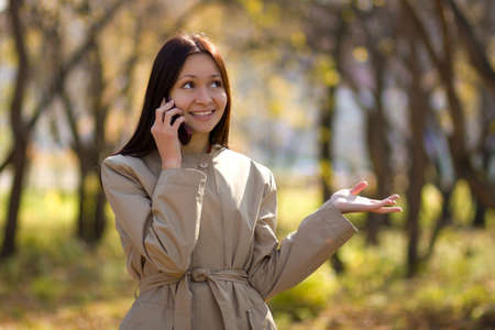 Pretty brunette caucasian girl on cellphoneの写真素材