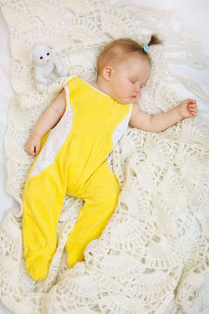 Little baby girl sleeping with her bear toyの写真素材