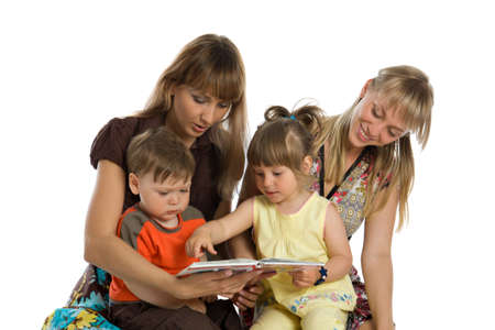 Two young mothers read books to their childrenの写真素材