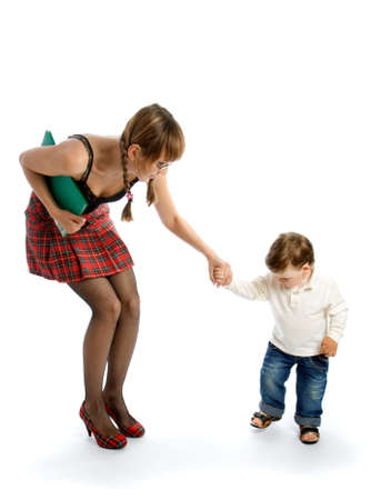 Young woman with a folder holding the hand of small childの写真素材