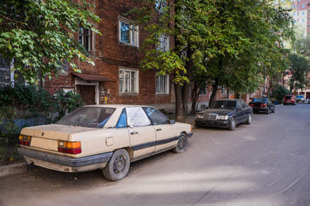 the Old dirty abandoned car flat tireの写真素材
