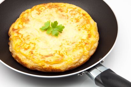 omelette of potato cooked in a frying panの写真素材