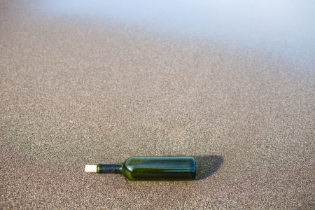 glass bottle on the sandの写真素材
