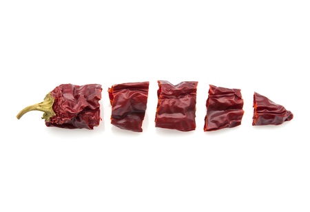 sliced cut piquant pepper on white fundの写真素材