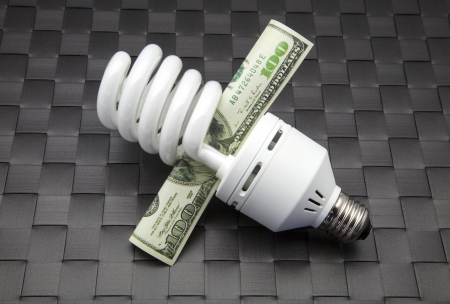 bulb of low consumption and ticket of dollarsの写真素材