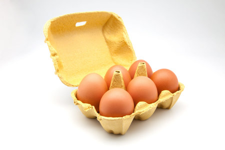 Six eggs in carton isolated on white