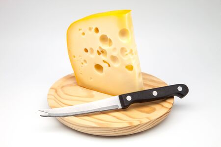 Emmental cheese on a  cutting boardの写真素材