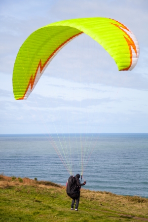 paragliding blast-off at the edge of the cliffの写真素材