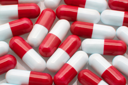 a heap of red and white capsulesの写真素材