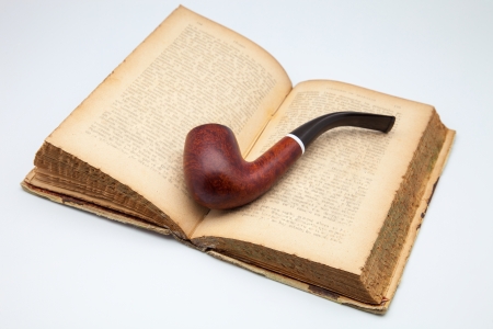 old book open with tobacco pipeの写真素材