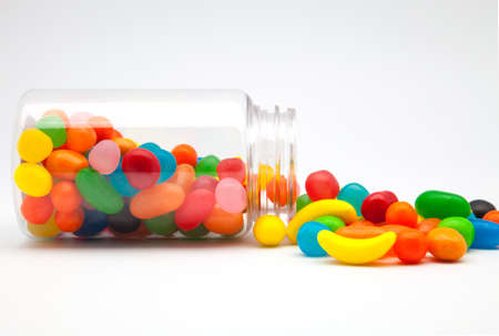 Candy in a glass jar on white backgroundの写真素材