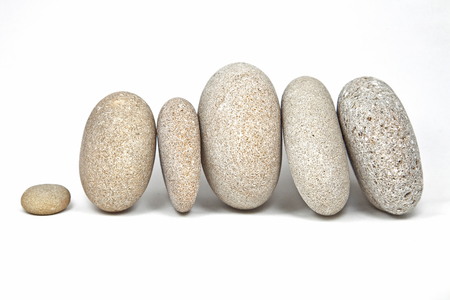 stones rounded poised on a white backgroundの写真素材