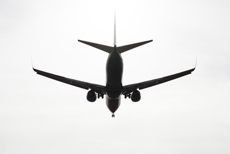 silhouette of aircraft flying in the skyの写真素材