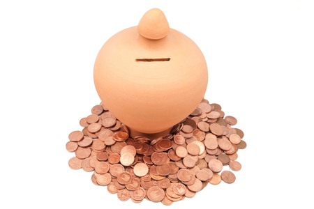 piggy bank with coins on a white backgroundの写真素材