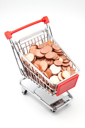shopping cart full of money on white backgroundの写真素材